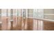 Spacious living room featuring gleaming hardwood floors, neutral paint and large columns at 102 Traviliah Oaks Ln, Cary, NC 27518
