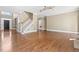 Spacious living room with hardwood floors, staircase, and elegant trim creates a warm and inviting atmosphere at 102 Traviliah Oaks Ln, Cary, NC 27518