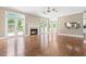 Open living room featuring fireplace and seamless flow to outdoor pool and kitchen spaces at 102 Traviliah Oaks Ln, Cary, NC 27518