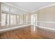 Elegant living room with hardwood floors, large mirrors, and French doors at 102 Traviliah Oaks Ln, Cary, NC 27518