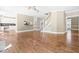 Spacious living room boasts hardwood floors and natural light from windows, plus views of the kitchen and staircase at 102 Traviliah Oaks Ln, Cary, NC 27518