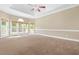 Spacious main bedroom with tray ceilings and large windows overlooking a backyard with privacy fence, for a relaxing retreat at 102 Traviliah Oaks Ln, Cary, NC 27518