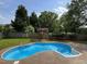 Outdoor kidney-shaped pool offers relaxation and recreation at 102 Traviliah Oaks Ln, Cary, NC 27518