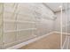 Spacious walk-in closet with ample shelving and carpet flooring at 102 Traviliah Oaks Ln, Cary, NC 27518