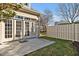 This backyard patio features a neutral fence, a small patch of grass, and a set of glass French doors at 103 Aisling Ct, Cary, NC 27513
