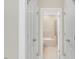 A hallway view leading to a bathroom with a tub and shower at 103 Aisling Ct, Cary, NC 27513
