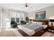 A beautifully decorated bedroom with a ceiling fan and seating near bright windows at 103 Aisling Ct, Cary, NC 27513