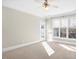A bedroom featuring neutral walls, carpet, and a back door at 103 Aisling Ct, Cary, NC 27513