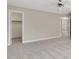 A bedroom with light-colored walls and carpet, offering a view into the walk-in closet and bathroom at 103 Aisling Ct, Cary, NC 27513
