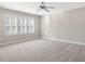 A bright bedroom with large windows featuring white shutters and neutral carpet, offering a serene and spacious atmosphere at 103 Aisling Ct, Cary, NC 27513