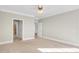 A spacious bedroom features neutral walls, a ceiling fan, and carpeted floors at 103 Aisling Ct, Cary, NC 27513