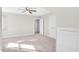 This bedroom features neutral walls and carpet, bright light, and a ceiling fan for added comfort at 103 Aisling Ct, Cary, NC 27513