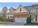 Well-maintained home with a two-car garage, brick accents, and manicured landscaping at 103 Aisling Ct, Cary, NC 27513