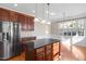 Kitchen boasts dark wood cabinets, a center island, and stainless steel appliances at 103 Aisling Ct, Cary, NC 27513