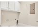A laundry room features upper cabinets, and hookups for a washer and dryer at 103 Aisling Ct, Cary, NC 27513