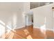 Open living area with hardwood floors, natural light, and a view of the staircase at 103 Aisling Ct, Cary, NC 27513