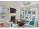 Bright living room with fireplace, hardwood floors, and access to outdoor space at 103 Aisling Ct, Cary, NC 27513