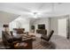 A spacious, light-filled living room with leather seating, a flat-screen TV, and a casual dining area at 103 Aisling Ct, Cary, NC 27513