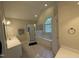 Bright bathroom with a soaking tub under arched window, and separate shower at 105 Dairy Ct, Chapel Hill, NC 27516