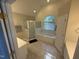Bright bathroom featuring a soaking tub, a glass-enclosed shower, and dual vanities at 105 Dairy Ct, Chapel Hill, NC 27516