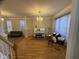 Bright living room featuring hardwood floors, a decorative chandelier, and lots of natural light at 105 Dairy Ct, Chapel Hill, NC 27516