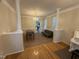 Open-concept living area featuring hardwood floors, decorative pillars, and large windows at 105 Dairy Ct, Chapel Hill, NC 27516