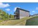 Expansive backyard with lush greenery, featuring a covered deck, ideal for outdoor relaxation and entertaining at 106 Neuse Bluff Cir, Clayton, NC 27527