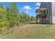 Beautiful backyard with a covered deck overlooking a wooded area, offering privacy and tranquility at 106 Neuse Bluff Cir, Clayton, NC 27527