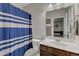 Bright bathroom with a striped shower curtain, a vanity with storage, and a clean, functional design at 106 Neuse Bluff Cir, Clayton, NC 27527
