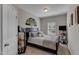 Stylish bedroom with a dark wood frame bed, soft gray bedding, and elegant wall decorations at 106 Neuse Bluff Cir, Clayton, NC 27527