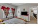 Comfortable bedroom featuring neutral tones, dresser with TV, and bright natural light at 106 Neuse Bluff Cir, Clayton, NC 27527