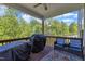 Inviting deck with patio furniture, a grill, and scenic wooded views, perfect for outdoor entertaining at 106 Neuse Bluff Cir, Clayton, NC 27527