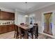 Cozy dining area with a dark wood table and chairs, near the kitchen and backyard access at 106 Neuse Bluff Cir, Clayton, NC 27527