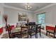 Elegant dining room with a large table set, decorative wall accents, and a chandelier at 106 Neuse Bluff Cir, Clayton, NC 27527
