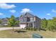 Two-story home boasts a well-manicured lawn, tree and a blend of siding and brick exterior at 106 Neuse Bluff Cir, Clayton, NC 27527