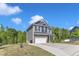A well-landscaped two-story home with a two-car garage is set against a clear blue sky at 106 Neuse Bluff Cir, Clayton, NC 27527