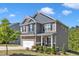Inviting two-story home with a charming front porch, well-maintained landscaping, and attached garage at 106 Neuse Bluff Cir, Clayton, NC 27527