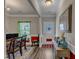 Welcoming foyer with decorative accents, wood floors, and natural light from the front door at 106 Neuse Bluff Cir, Clayton, NC 27527