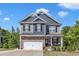 Charming two-story home featuring a stone and siding exterior, well-maintained landscaping, and an attached two-car garage at 106 Neuse Bluff Cir, Clayton, NC 27527