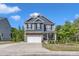 Two-story home boasts a mix of stone and siding, complemented by a well-manicured lawn, enhancing its curb appeal at 106 Neuse Bluff Cir, Clayton, NC 27527