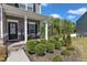 Inviting front porch with stone accents, decorative plants, and cozy seating, adding charm to the home's entrance at 106 Neuse Bluff Cir, Clayton, NC 27527