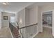 Hallway with carpeted floors, neutral walls, and decorative railing overlooking the living area at 106 Neuse Bluff Cir, Clayton, NC 27527