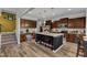 Well-equipped kitchen with dark wood cabinets, granite countertops, and an island with seating at 106 Neuse Bluff Cir, Clayton, NC 27527