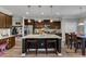 Spacious kitchen boasts granite countertops, stainless appliances, dark cabinets and island seating at 106 Neuse Bluff Cir, Clayton, NC 27527