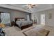Serene main bedroom featuring tray ceiling, patterned wallpaper, and abundant natural light at 106 Neuse Bluff Cir, Clayton, NC 27527