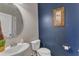 Stylish powder room featuring a unique vanity and contrasting wall paint, adding a modern touch at 106 Neuse Bluff Cir, Clayton, NC 27527