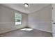 Sunlit carpeted bedroom with chair rail showcasing a bright window view and ample space at 109 Stone Ridge Dr, Smithfield, NC 27577