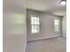 Bright bedroom featuring neutral walls, carpet flooring, and two windows at 109 Stone Ridge Dr, Smithfield, NC 27577