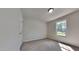 This bedroom has neutral carpeting, chair rail molding, a window and a standard ceiling light fixture at 109 Stone Ridge Dr, Smithfield, NC 27577