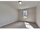 Bright carpeted bedroom featuring chair rail and a large window offering natural light and a peaceful setting at 109 Stone Ridge Dr, Smithfield, NC 27577